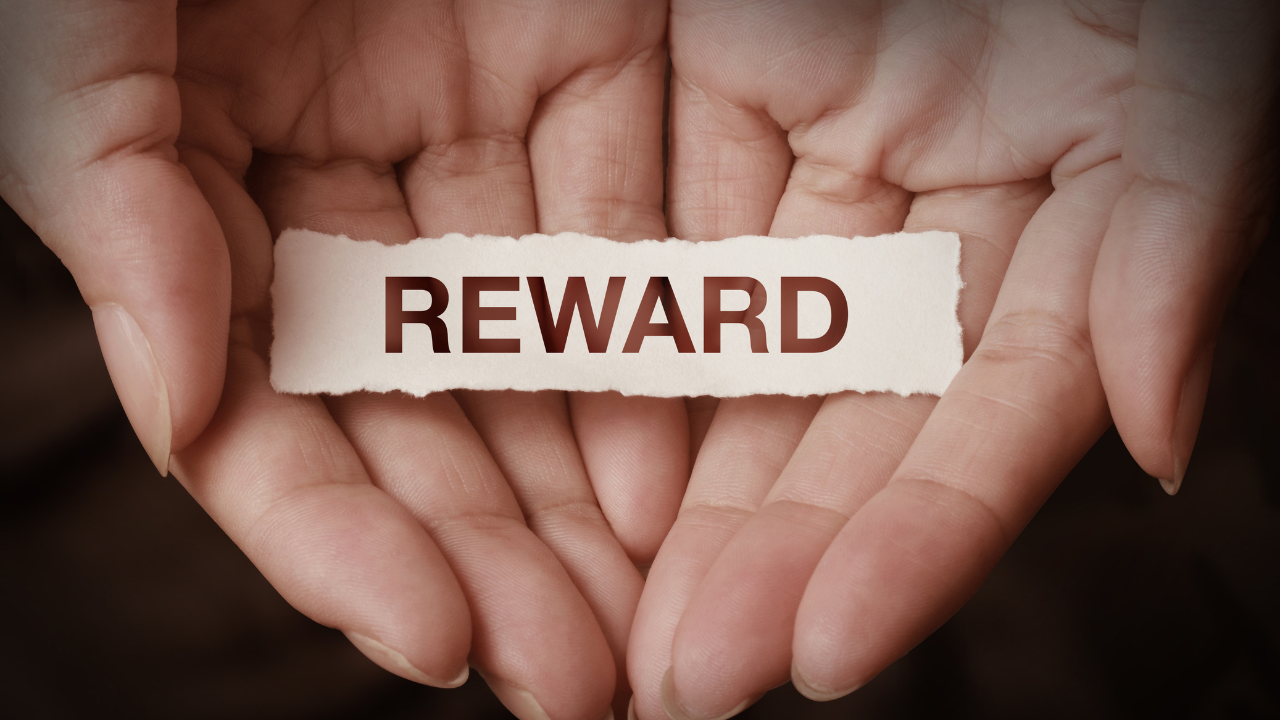 rewardの紙を手に置いてる人